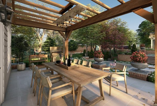 Outdoor dining patio under a wooden pergola, overlooking a terraced garden with brick retaining walls and lush plantings.
